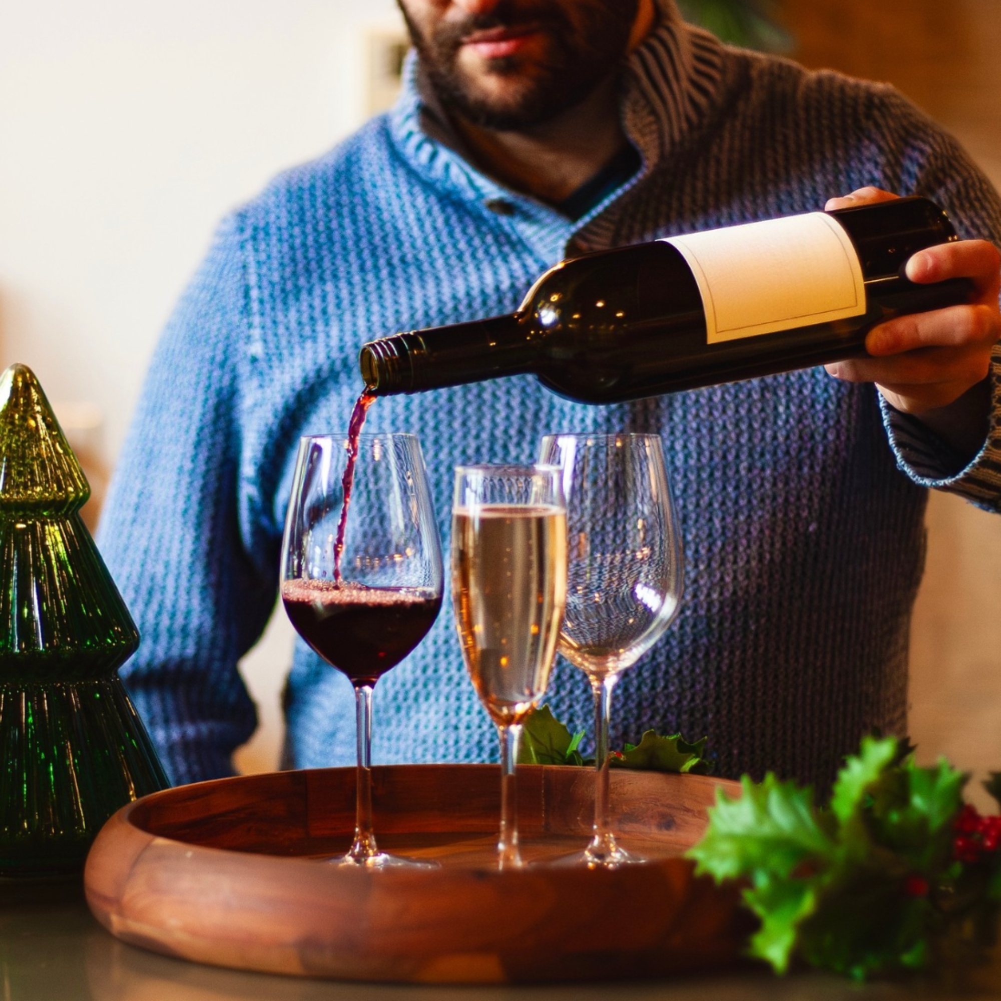 Zach Glassman pouring wine at an event